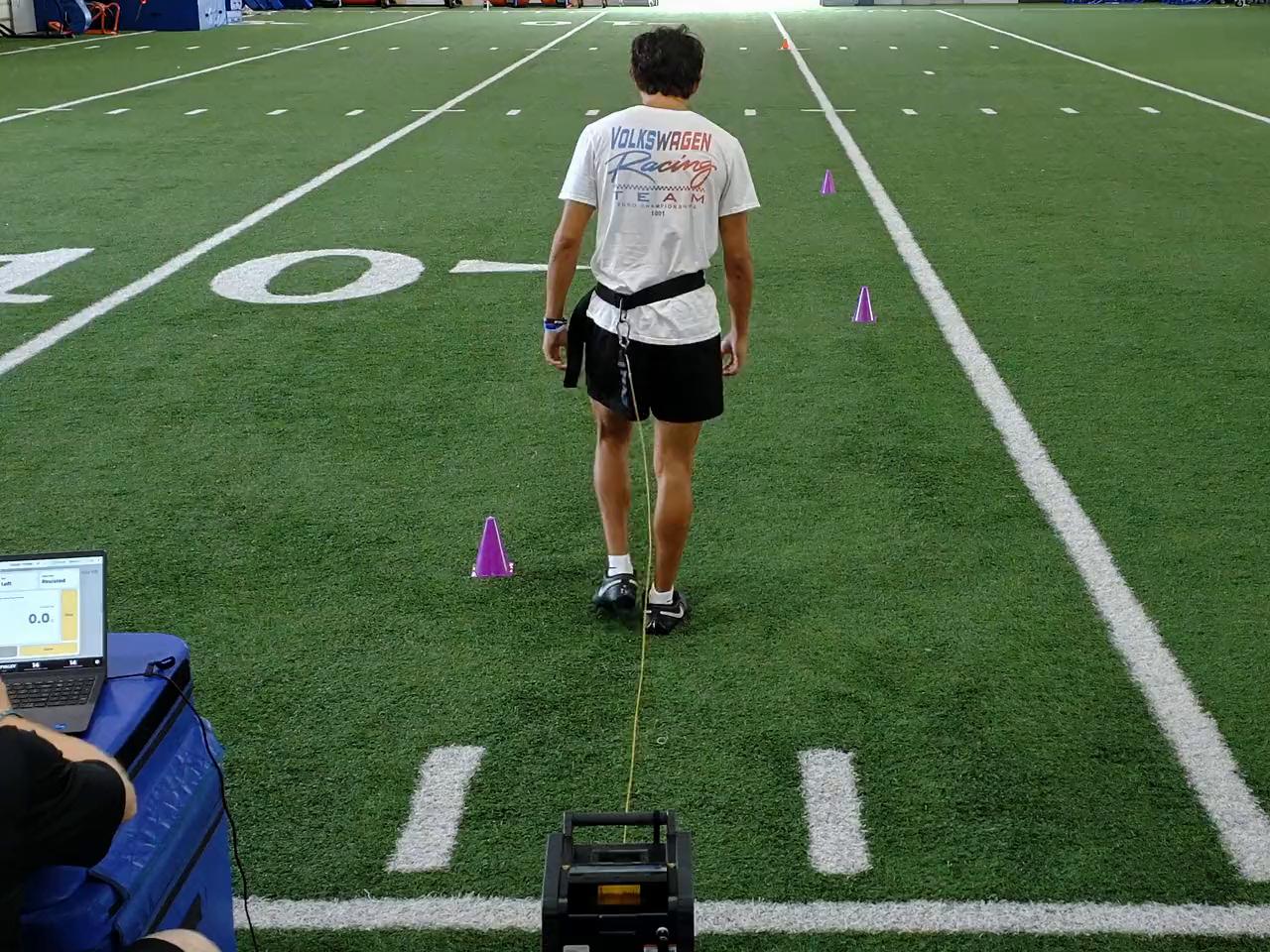 Athlete tethered to the 1080 Sprint while its software shows live data on a laptop